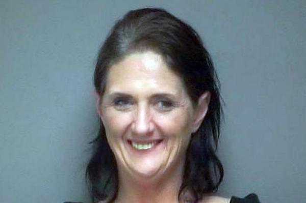 0 woman 57 smiles in her mugshot after shes arrested for handing out marijuana infused cookies and