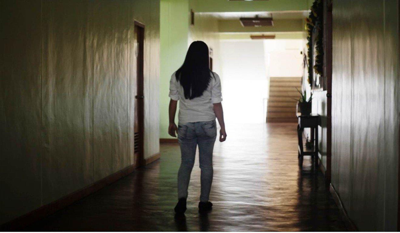 A victim of trafficking is pictured walking down a corridor in a church in Tagaytay, the Philippines. Photo: Reuters