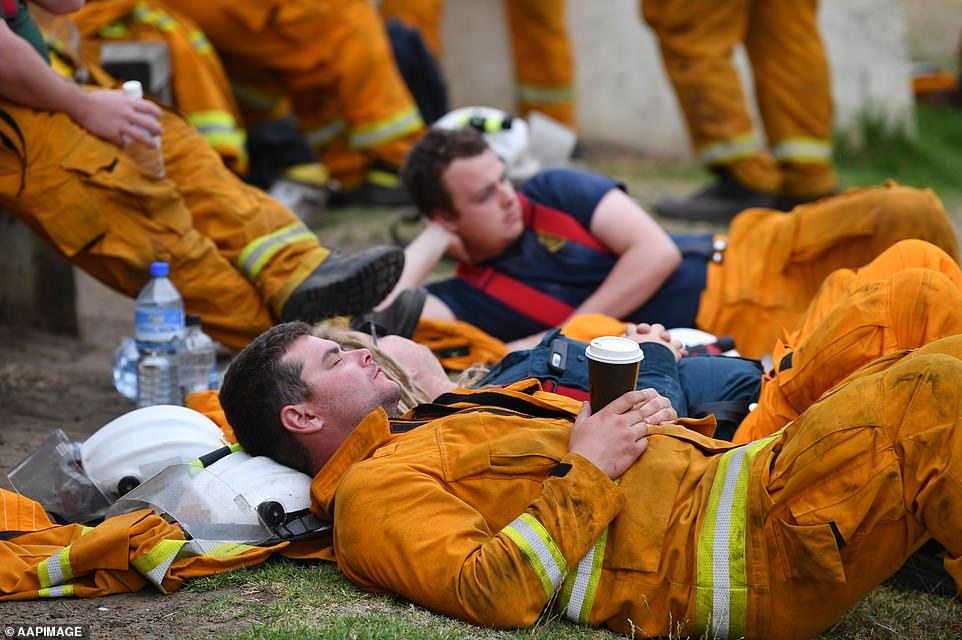 Shattered: Firefighters are seen at Kingscote oval after fighting fires through the night, on Kangaroo Island